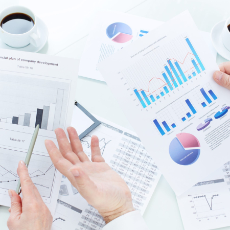Above angle of mature business partners hands during analysis of marketing